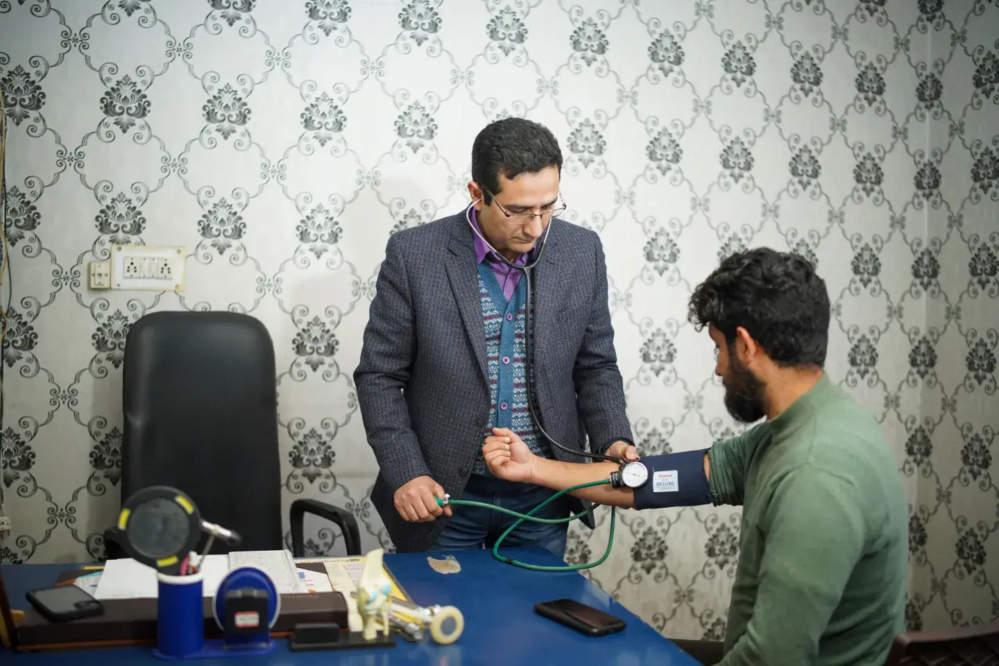 A doctor checking a patient during a community health consultation