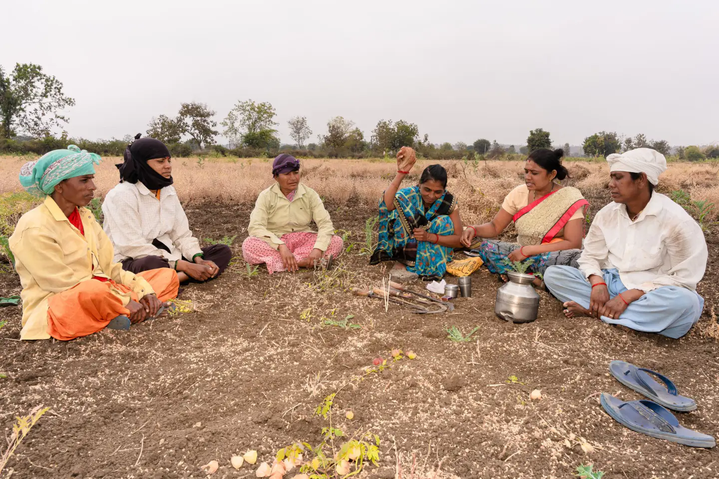 A group of farmers sitting together in conversation during a break in rural Nagpur, India