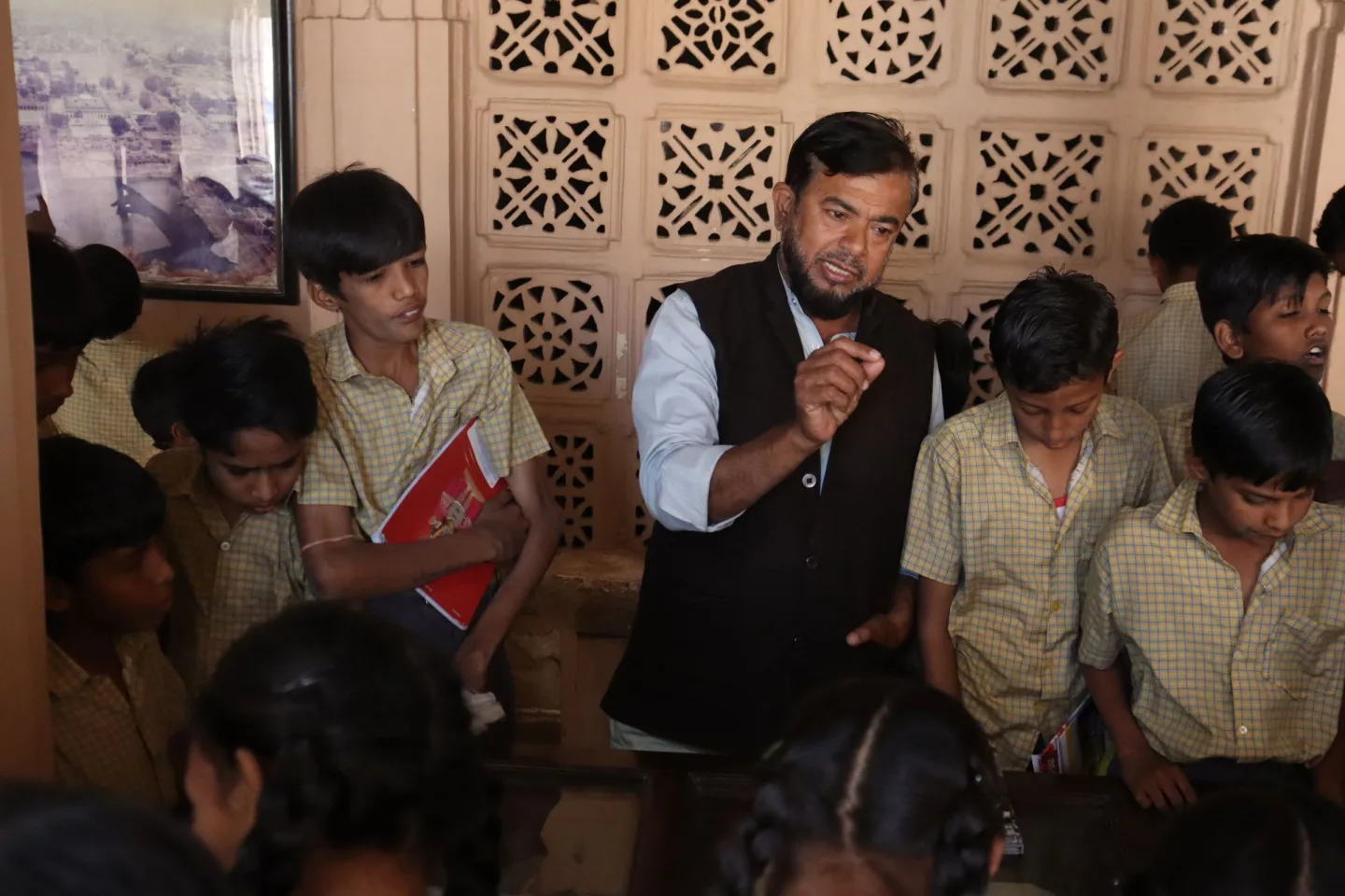 A teacher guiding students during a session at a government school in India