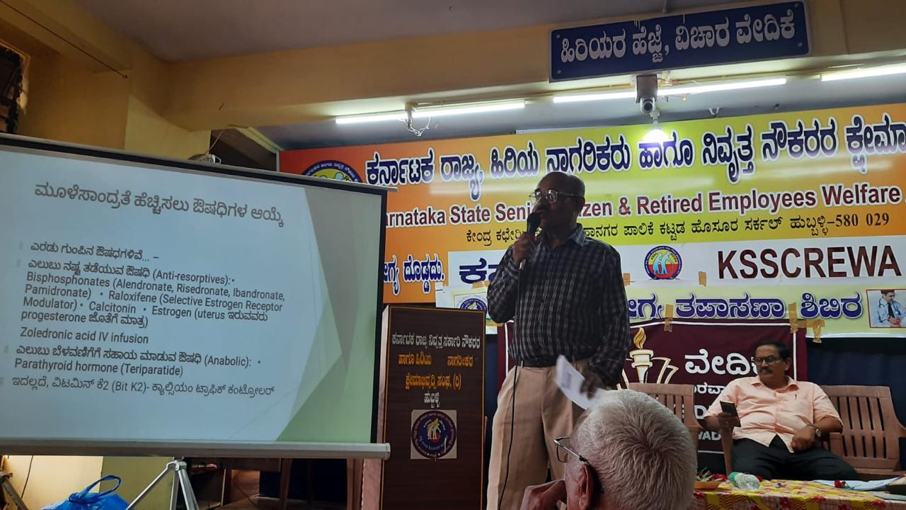A doctor presenting a slide on the medicines used to increase bone density, at the KSSCREWA hall in Hubballi