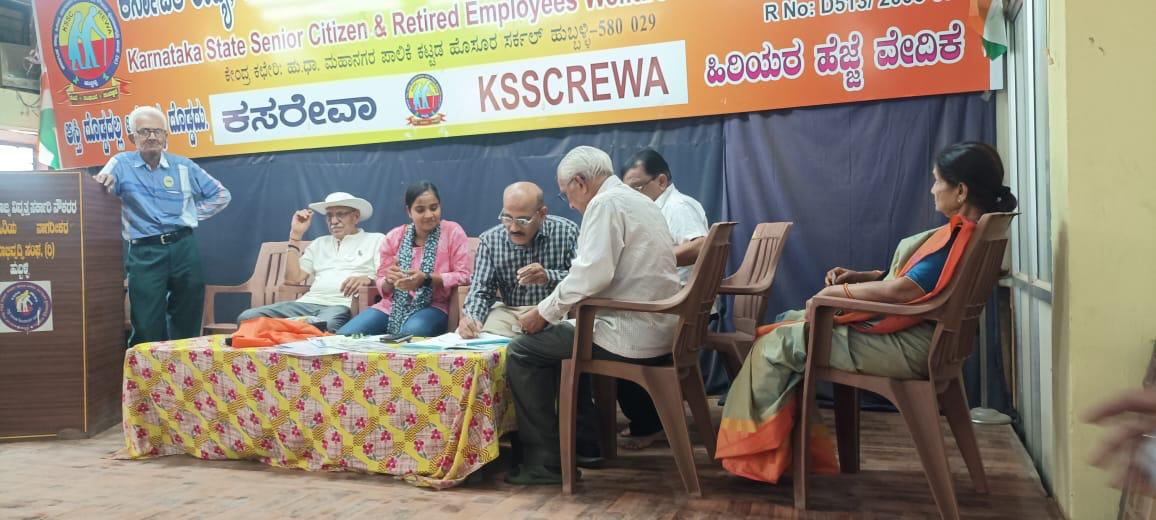 Attendees registering at a desk under the KSSCREWA banner